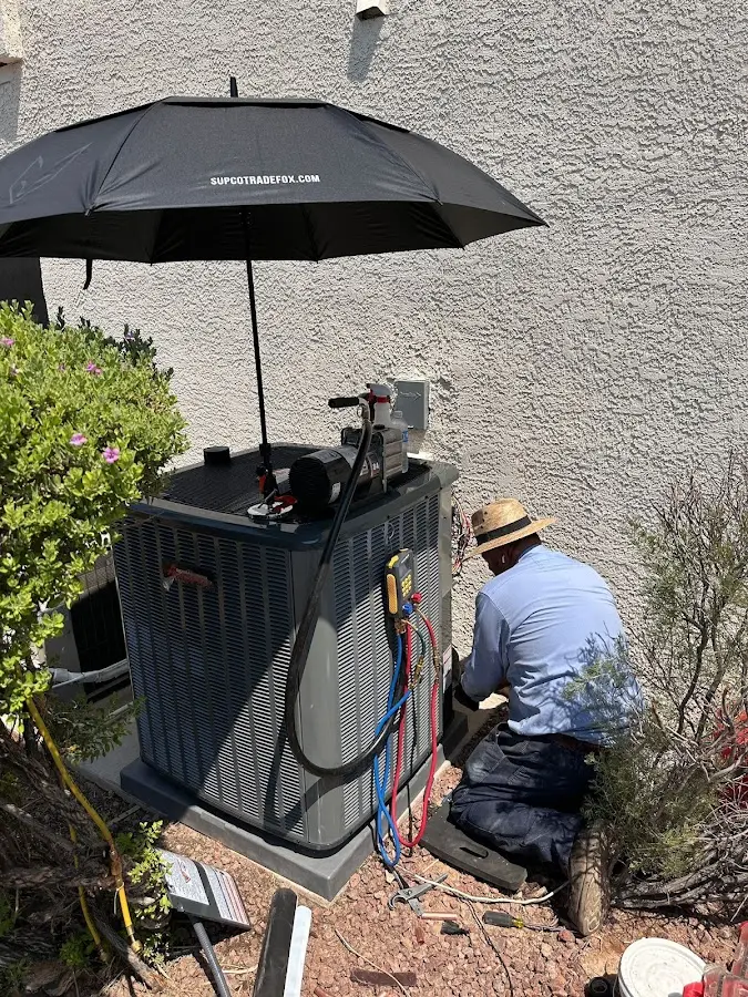 HVAC technician performing outdoor AC maintenance in Highgrove